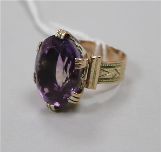 An engraved yellow metal and amethyst set dress ring, size L.